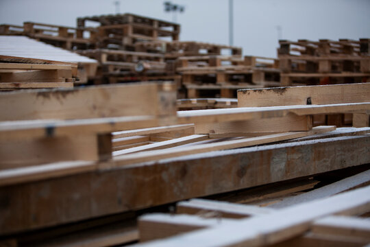 Pile of wooden pallets at a construction site