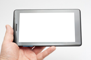 Hand holding a digital tablet with blank white screen
