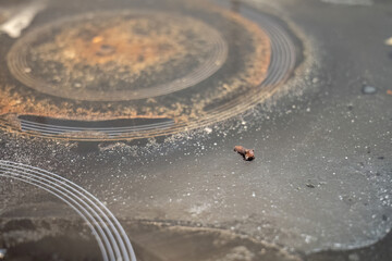 Dirty glass stovetop with burnt residue and grease stains
