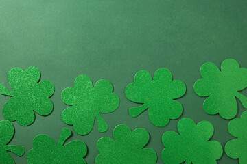 St. Patrick's day frame with clover leaves on green background. Flat lay. View from above. Greeting...