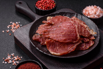 Jerky, dried pork meat slices with salt and spices