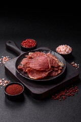 Jerky, dried pork meat slices with salt and spices