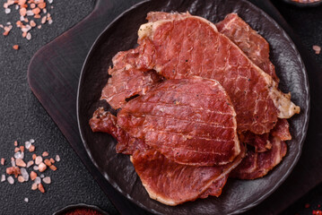 Jerky, dried pork meat slices with salt and spices