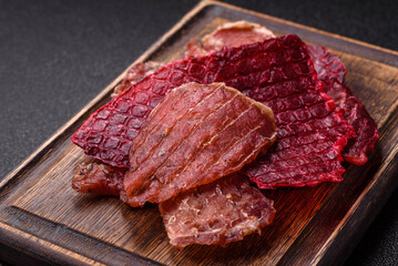 Jerky, dried pork meat slices with salt and spices