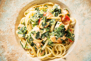 Creamy Pasta Dish Featuring Chicken, Spinach, and Sun-Dried Tomatoes on a Rustic Plate Adorned With Subtle Textures and Earthy Tones.