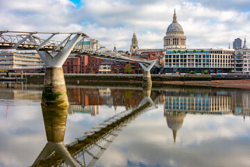 Fototapeta premium St. Paul's cathedral and Millennium bridge over Thames river, London, UK
