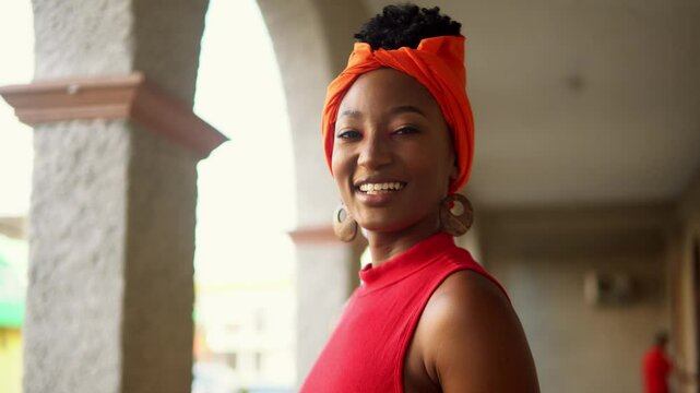 Beautiful garifuna woman smiling wearing traditional orange headwrap
