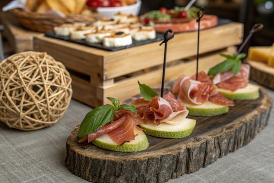 Elegant gourmet appetizers with prosciutto, cheese, and basil on a rustic wooden board