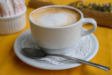Delightful morning coffee served in a charming cafe setting with vibrant yellow tablecloth