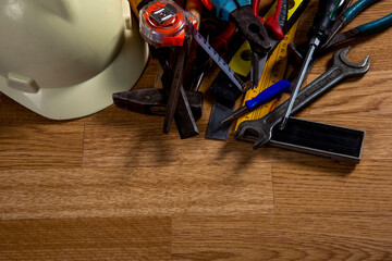 Old carpentry work tools on a  wooden table background.