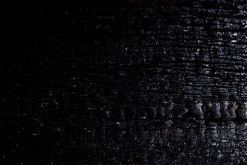 Close-up black and silver background texture of burnt wood.