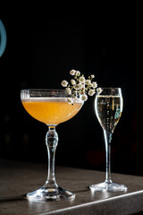 Delightful Cocktail Experience at a Stylish Bar With Floral Garnish and Sparkling Drink.