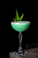 Enjoying a Refreshing Cocktail at a Trendy Bar on a Lively Evening With Vibrant Colors and Exquisite Flavors in a Sophisticated Glass.