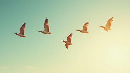 Obraz premium A group of migratory birds flying in a V formation across a clear blue sky, symbolizing unity and nature's beauty