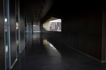 Archway passage between modern buildings. Reflections.