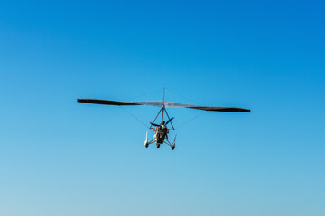 Hang glider for riding tourists in the field. Two-seater hang glider flying in the sky