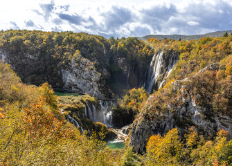 Stunning waterfalls in Plitvice Lakes National Park. Crystal-clear water descends in multiple...