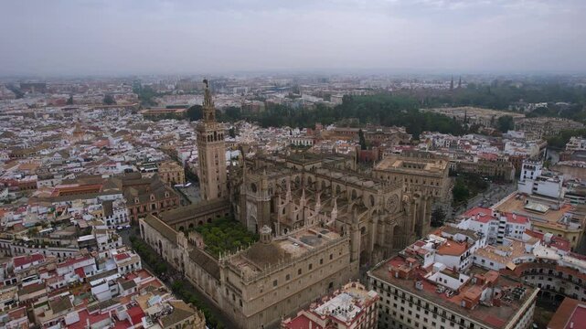 The drone aerial view of Seville Cathedral (Catedral de Santa Maria de la Sede de Sevilla) and old town of  Seville, Spain. It is the largest Gothic church in the world.
