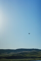 Hang glider for riding tourists in the field. Two-seater hang glider flying in the sky