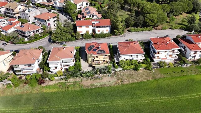 Aerial view of houses, park road, landscape, farmland, olive trees in the town of Roseto degli Abruzzi in Italy. Sunny day.
