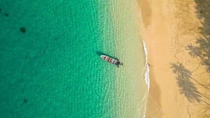 An aerial view of a boat in amazingg crystal  waters of Principe Island