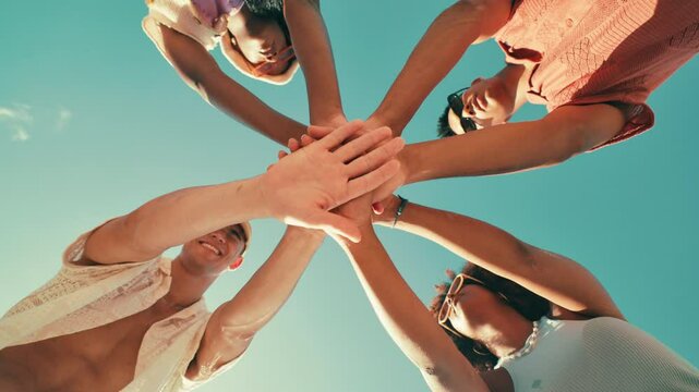 Unity, blue sky and people with stack of hands in circle for collaboration, motivation and support. Teamwork, diversity and group of friends in huddle for community, solidarity and trust from below.