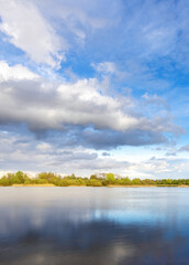 Calm lake with a cloudy sky in the background