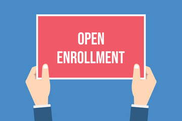 The human hands holds a open enrollment sign	
