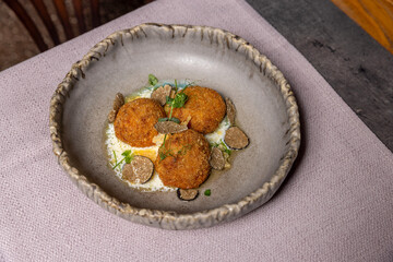 Crispy burrata with tartufo sauce served on a restaurant table