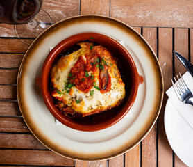 Delicious fried eggplants and tomatoes with parmesan cheese served in bowl