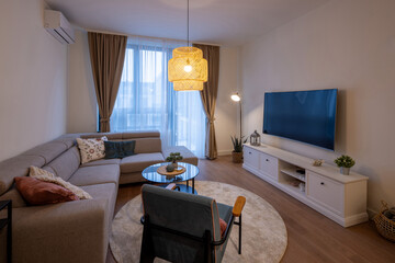 Modern living room with a sectional sofa, decorative lighting, a round coffee table