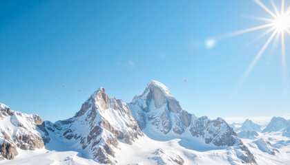 Obraz premium Aerial view of snow-capped mountains under bright sunshine, nature's grandeur