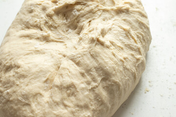 Homemade wheat flour dough for bread or pizza. Close-up. Top view.