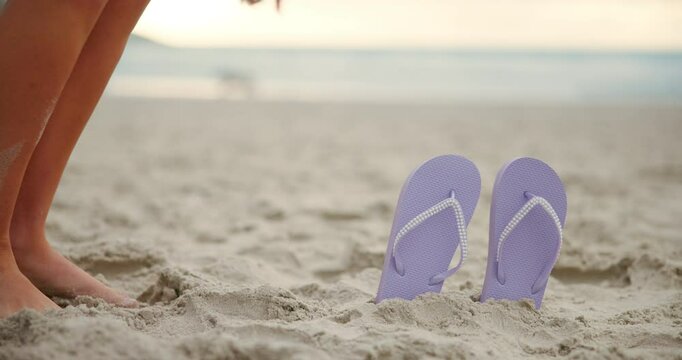 Beach, sandals and feet of woman on sand running to comfortable footwear in outdoor holiday. Closeup, girl walking and barefoot female person picking up flip flops or slippers on vacation break