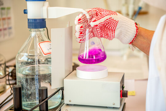 Laboratory equipment, titration of permanganate index. Manual titration station with brown bottle.