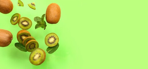 Flying kiwi and mint on green background with space for text