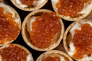 a quick snack from a waffle cup with buttercream and natural red caviar