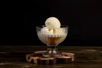 creamy balls of fresh white ice cream with the taste of maple syrup in a glass