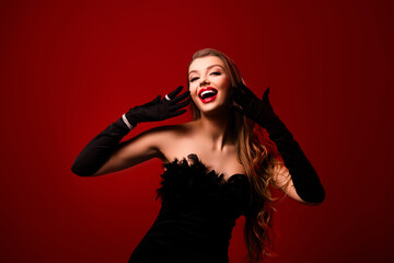 Photo of pretty lady with wavy brown hair raise hands wearing black gloves expensive precious gems on red background