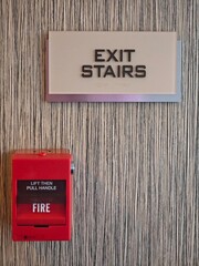Emergency exit signage and fire alarm box guide safety in a modern building corridor