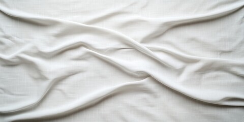 Soft white fabric draped on a surface creating elegant folds and smooth texture