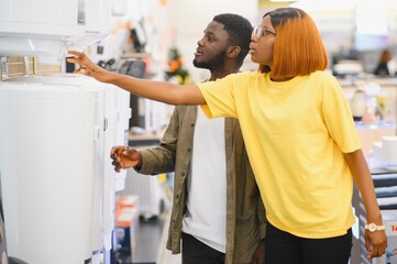 Happy african american young man and woman buying new heating water boiler
