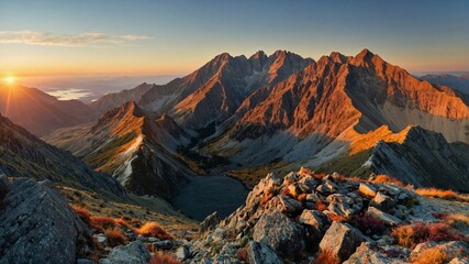 Stunning sunrise over rugged mountain peaks with rocky terrain and vibrant colors in a serene landscape