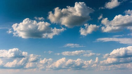 Beautiful cotton-like clouds drift across a bright blue sky during midday in a serene outdoor setting
