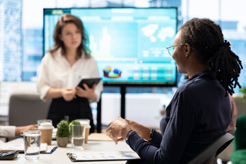 Fototapeta premium PR team presenting infographics and digital marketing insights for growth, showcasing the impact of recent campaigns and outlining plans for future development initiatives in workspace.