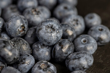 a pile of blueberries scattered on the board