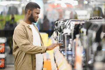 Man choosing coffee machine in mall