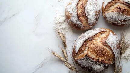 Three artisan sourdough loaves with wheat.
