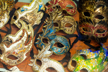 Colorful carnival masks on street sale in Venice. Luxury masquerade accessories and souvenirs..