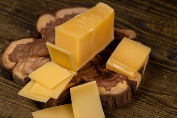 a piece of sliced hard mature cheese in close-up